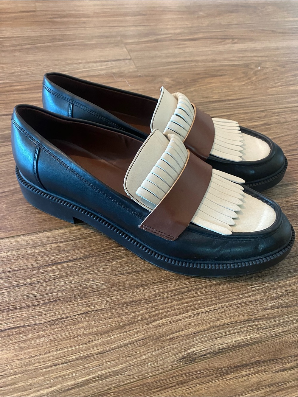 Marc Fisher Women's Calixy Fringe Slip-On Loafers in black, brown & white. 10M